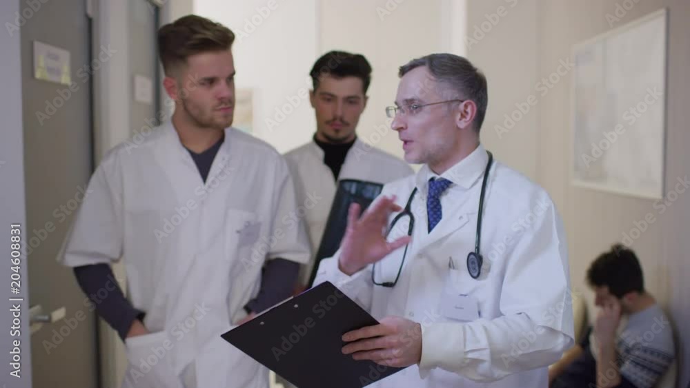 Doctor and residents talking Doctor and residents talking
