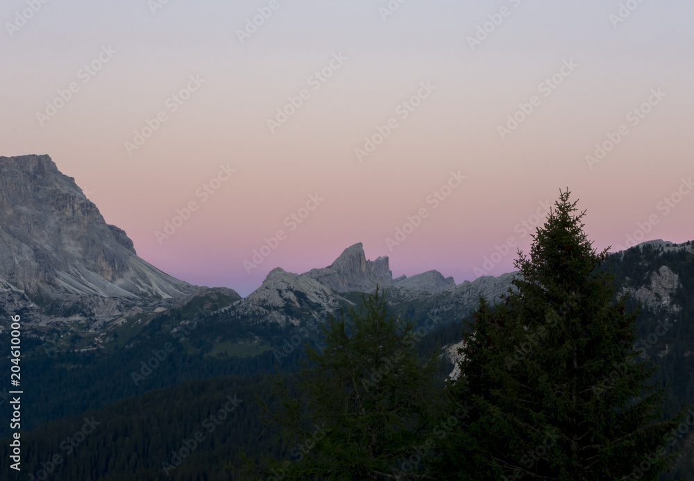 Dolomites sunset during summer time. Landscape to Conturines and Lagazuoi peaks and Falzarego mountain pass