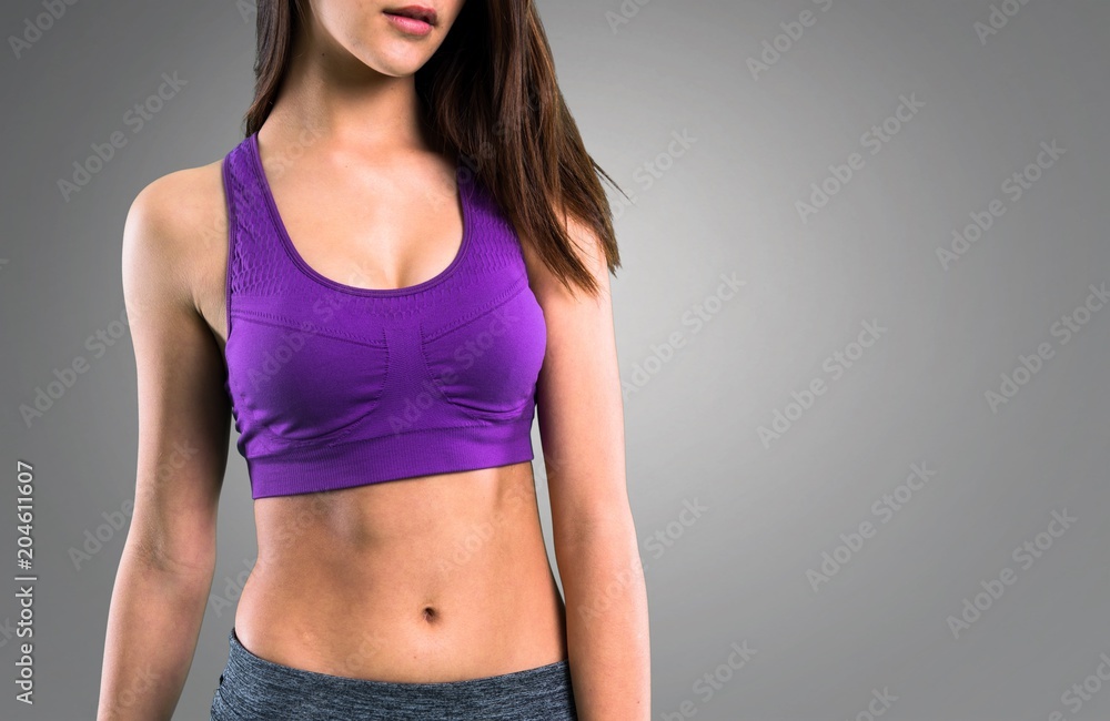 Fototapeta premium Young sport girl on grey background