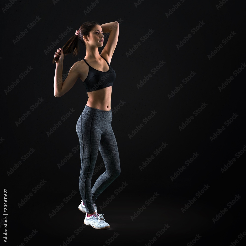 Young sport girl on black background Young sport girl on black background