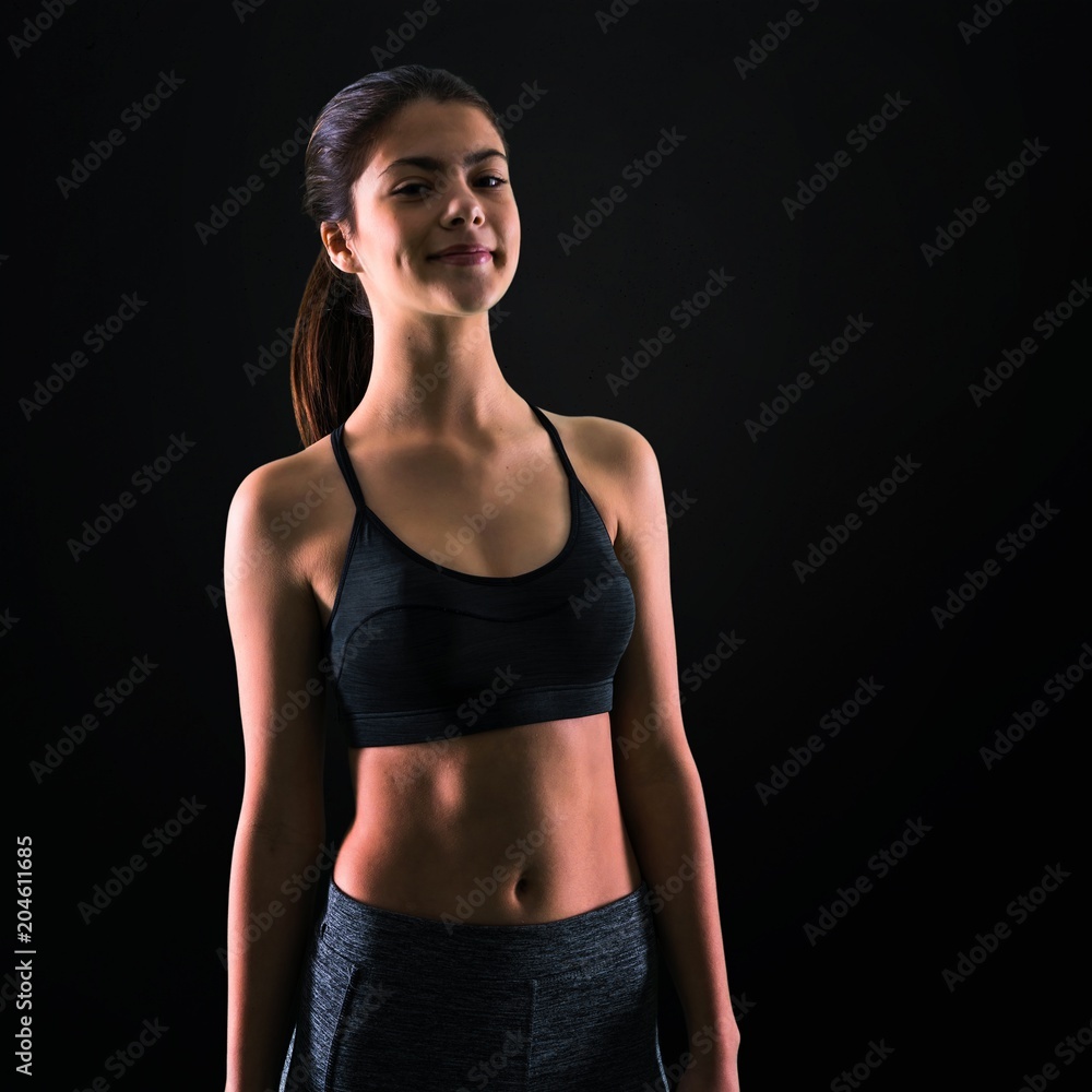 Young sport girl on black background Young sport girl on black background