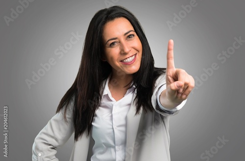 Wallpaper Mural Pretty woman counting one on grey background Torontodigital.ca