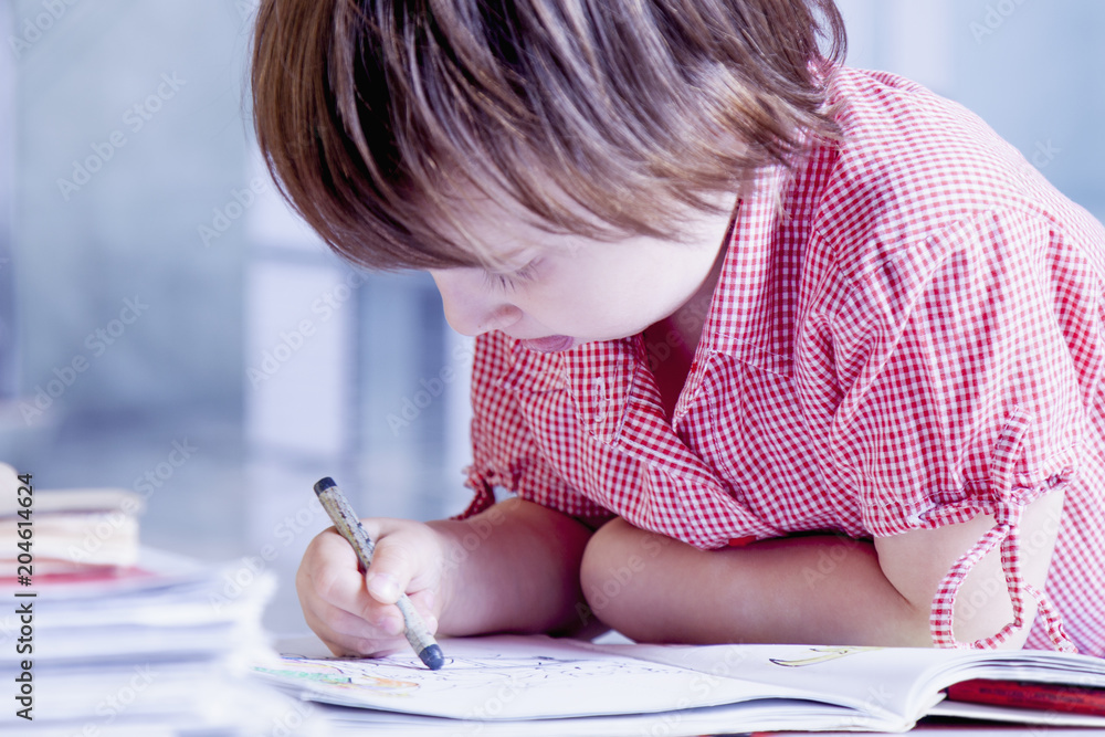 Humorous portrait of child girl artist designer draws a pencil sketch. Close up. Humorous portrait of child girl artist designer draws a pencil sketch. Close up.