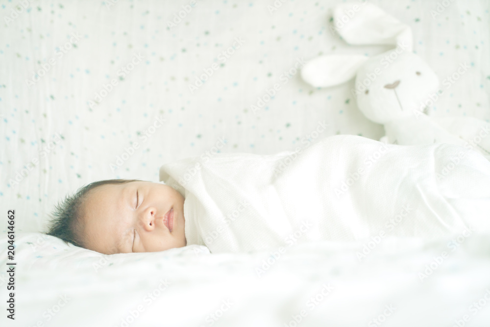 Cute adorable newborn baby boy wrapped or swaddle in a blanket
