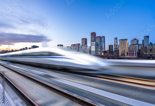 high speed train with cityscape photo