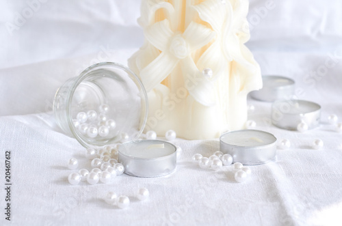 candle, white beads and glass bowl
