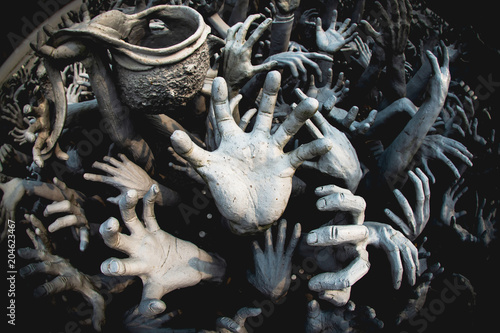 A statue of a hand that emerges from the ground, represents the abstract of good doing, and hell and heaven.
