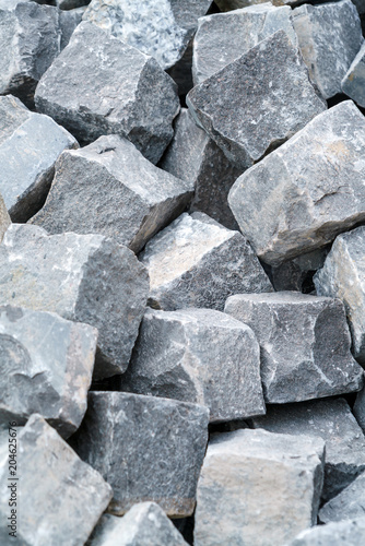 A pile of processed pieces of granite prepared for work on paving