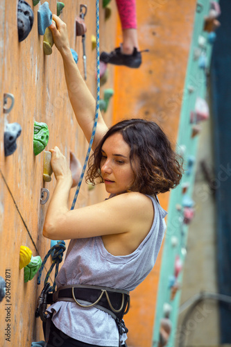  girl climbing up the wall