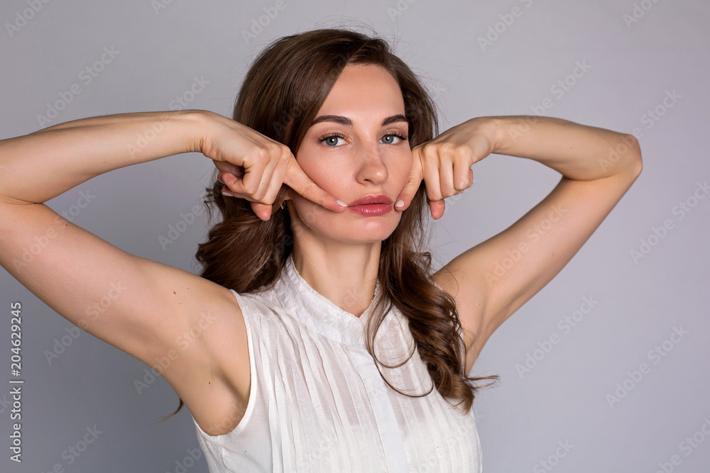 young woman makes herself a massage complex of exercises young woman makes herself a massage complex of exercises