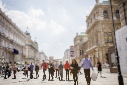 Crowd of anonymous people walking on busy vienna city street © babaroga