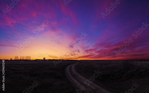 Sunset over the field colorfull with road to future