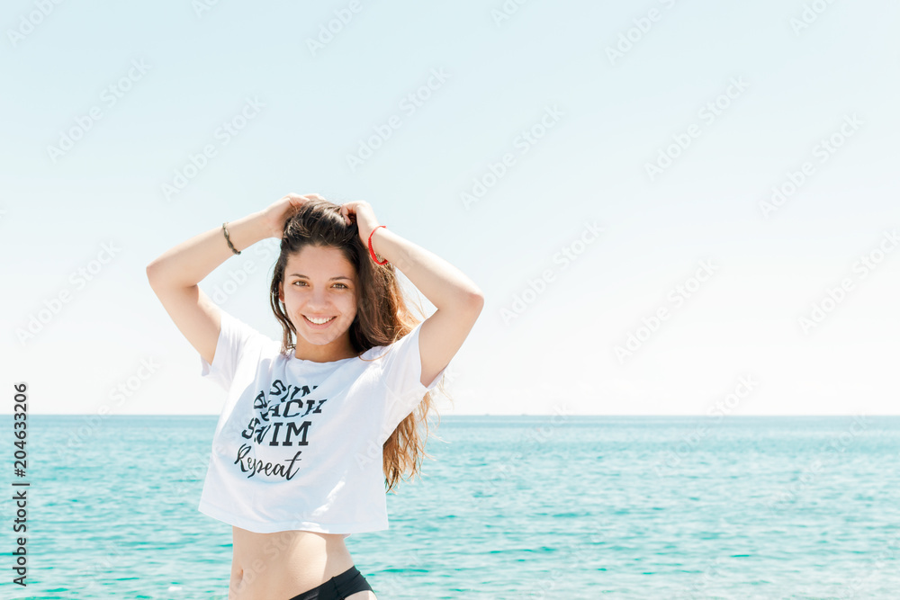 Relaxed woman enjoying sun, freedom and life on beautiful beach in sunshine. Concept of vacations. Relaxed woman enjoying sun, freedom and life on beautiful beach in sunshine. Concept of vacations.