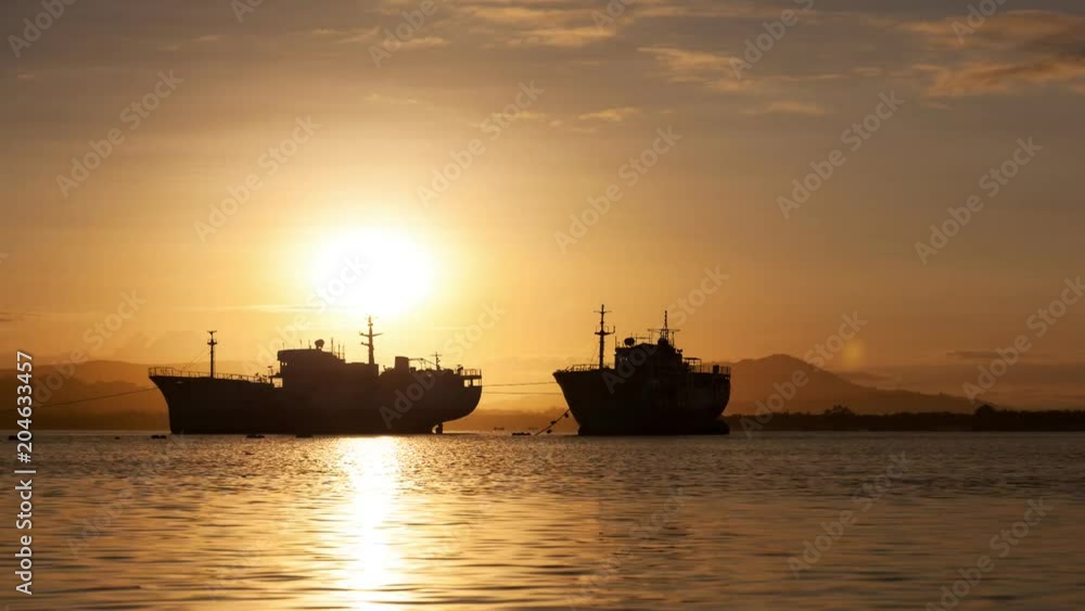4-K Time lapse of old big transport boats in the morning sunrise 4-K Time lapse of old big transport boats in the morning sunrise