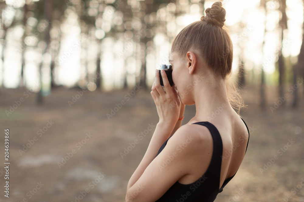 Hipster girl with using vintage photo camera close up, copy space of blank empty mockup, view tourist holding in hands and photograph on device travel on background