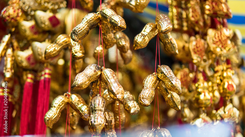 Chinese souvenir market. .Еraditional Chinese amulets and souvenirs in gold close-up. photo