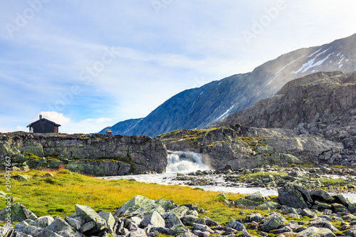 Mountain house near waterfall at Hjelledalen, Norway photo