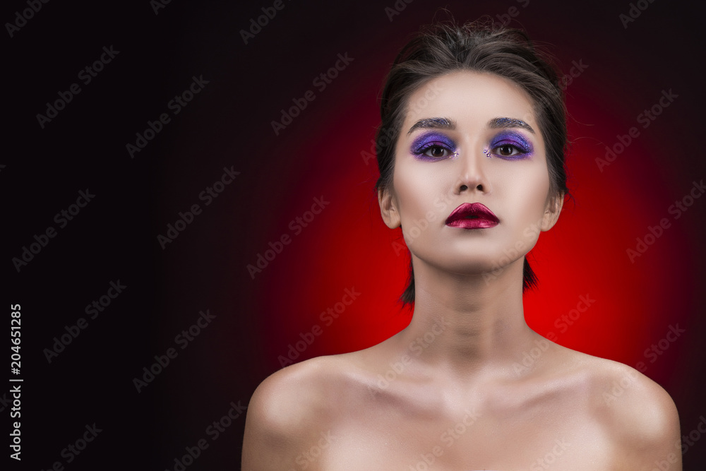 Portrait of a beautiful big breasted asian girl wearing deep decollete and aggressive red lips makeup. Portrait of a beautiful big breasted asian girl wearing deep decollete and aggressive red lips makeup.