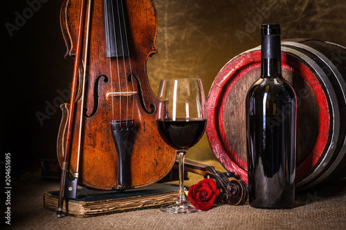 Red wine in glass, barell and violin photo