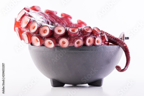 Beautiful octopus tentacle in the black bowl