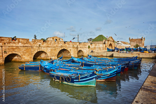 Fort of Essaouira in Morocco on a sunny day with blue boats on the water
