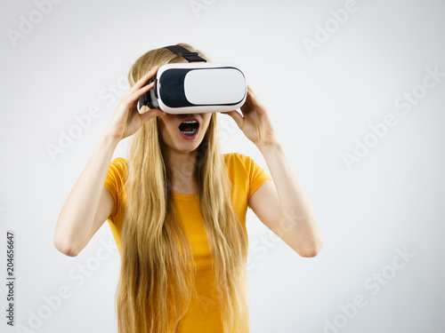 Girl wearing virtual reality goggles. © Voyagerix