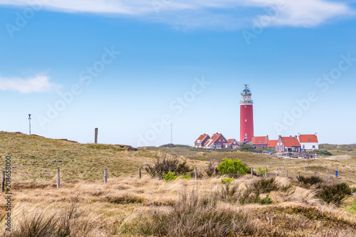 Panorama with red lighthouse at wadden island Texel in the Netherlands taken form the sand dunes of teh village Cocksdorp.