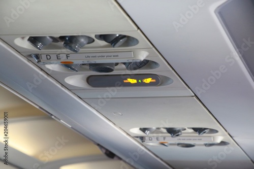 Air Vents and Fasten Seatbelt Signs Line Up the Ceiling in a Commercial Jet Waiting for Takeoff