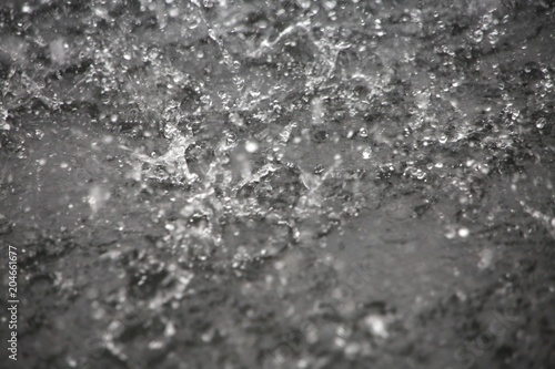 Raindrops Splattering on Pavement During a Torrential Downpour in Florida in June