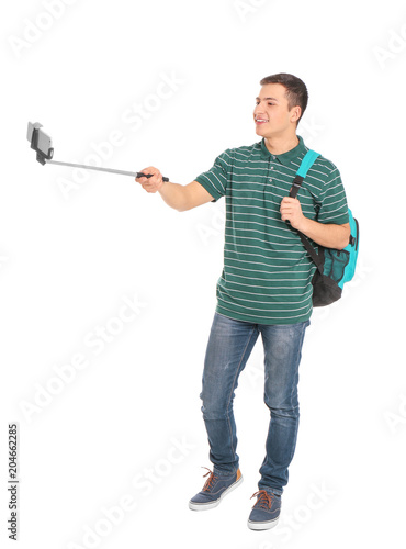 Young handsome man taking selfie against white background