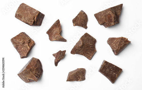 Composition with delicious chocolate chunks on white background