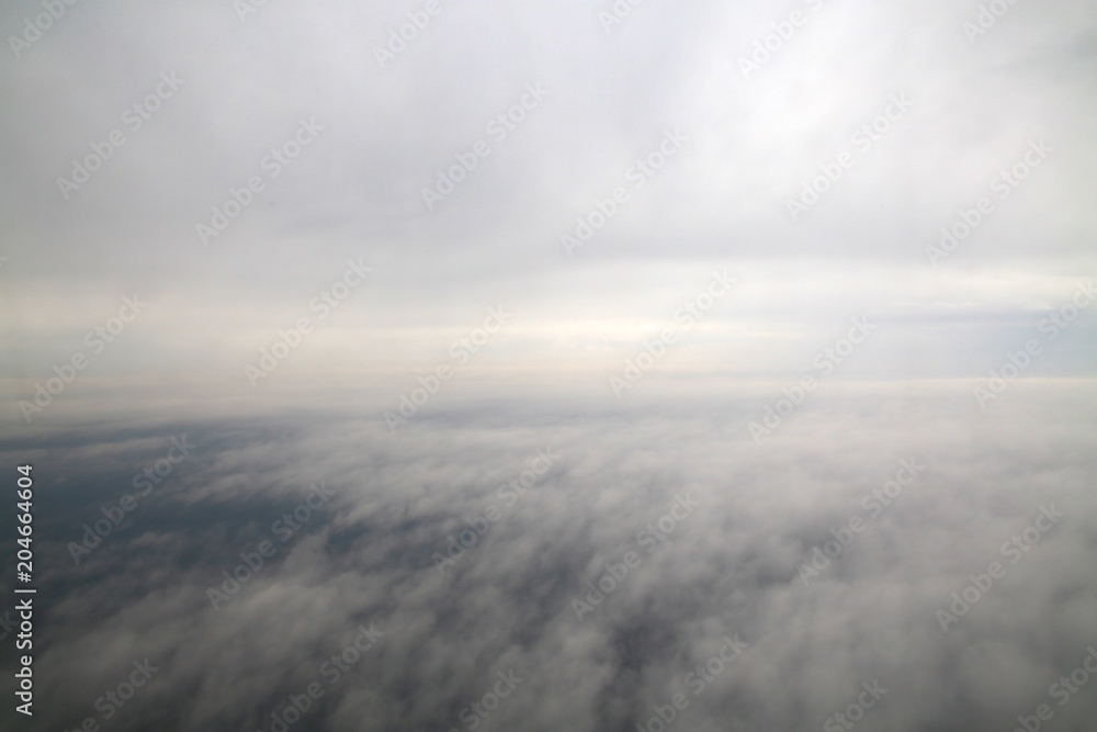 Between Layers of Clouds in a Commercial Jet in an Overcast Day