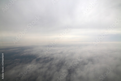 Between Layers of Clouds in a Commercial Jet in an Overcast Day