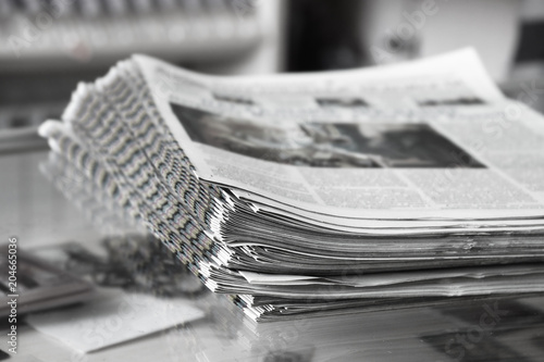 Stack of newspapers on the newspaper stand, close up photo