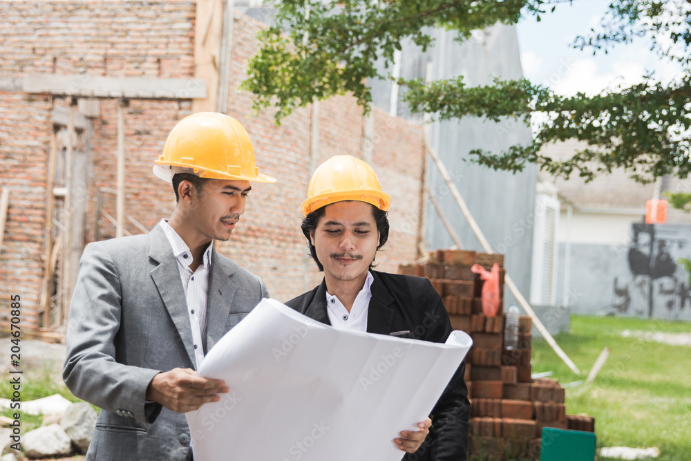 designers discussing house construction plan designers discussing house construction plan