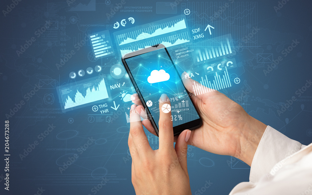Female hand using smartphone with financial tracking concept illustrated by graphs and symbols