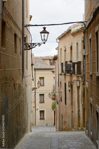 Old street on a cloudy day in the center of Segovia Spain