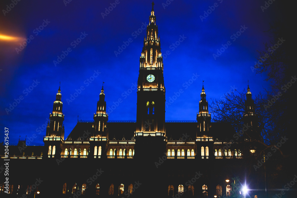 Fototapeta premium Night view of Vienna New City Hall, also known as Wiener Neue Rathaus, the seat of local government of Vienna, located on Rathausplatz in the Innere Stadt district.