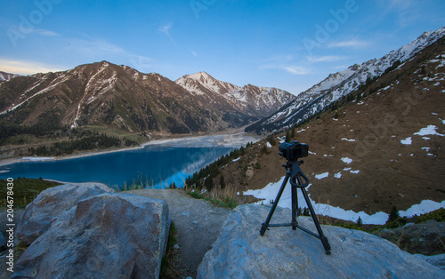 camera on the mountain lake background