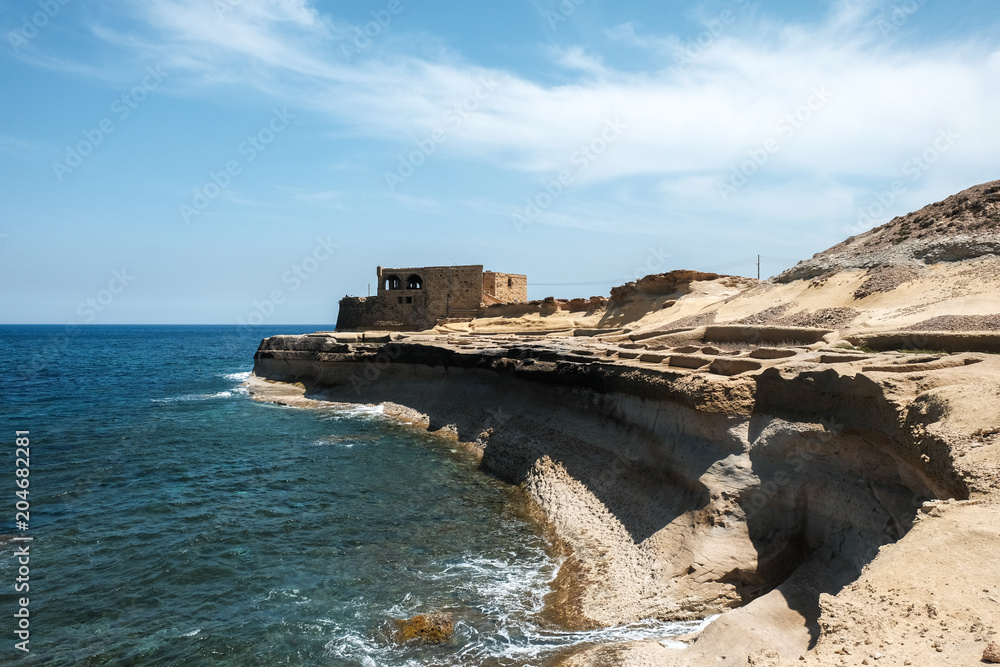 Obraz premium salt pans and abandoned building at Gozo islands, Malta