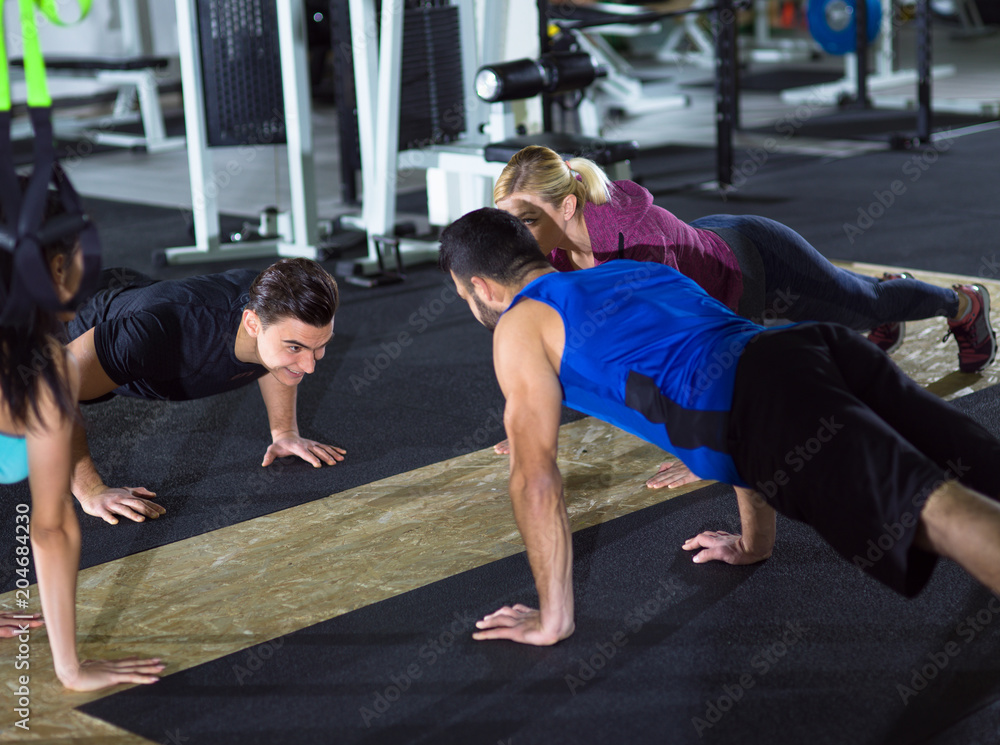 young healthy people doing pushups young healthy people doing pushups
