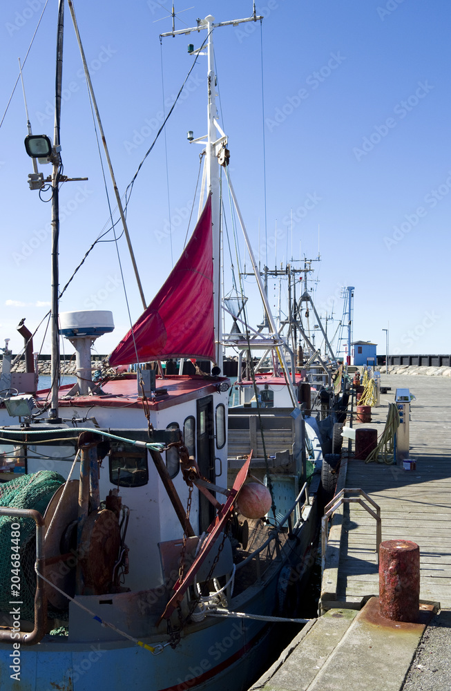 Laesoe / Denmark: Fishing cutters moored at the pier in the small fishing  port of Oesterby Havn in April Stock Photo