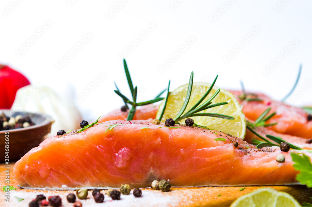 Salmon slices with cooking ingredients on a table