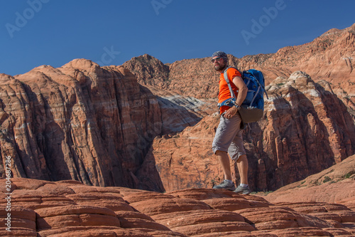 Hiker on a trail in volcanic Snow canyon State Park in Utah, USA