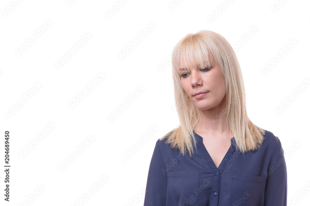 Thoughtful dejected blond woman with downcast eyes Thoughtful dejected blond woman with downcast eyes