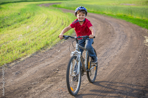 boy ride on bike at rural road