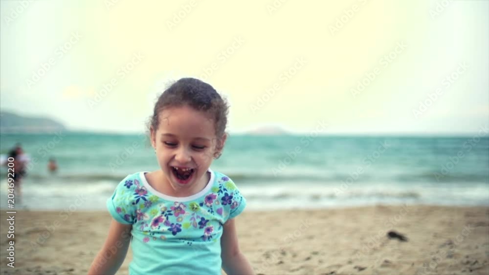 Little girl on the beach, happy little baby playing with sand on the beach. A child, a child, children, emotions. Little girl on the beach, happy little baby playing with sand on the beach. A child, a child, children, emotions.