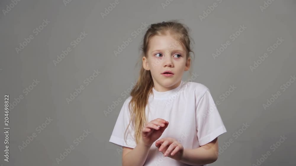 Scared young girl expressing fear emotion isolated on grey background. Concept of emotions. Scared young girl expressing fear emotion isolated on grey background. Concept of emotions.