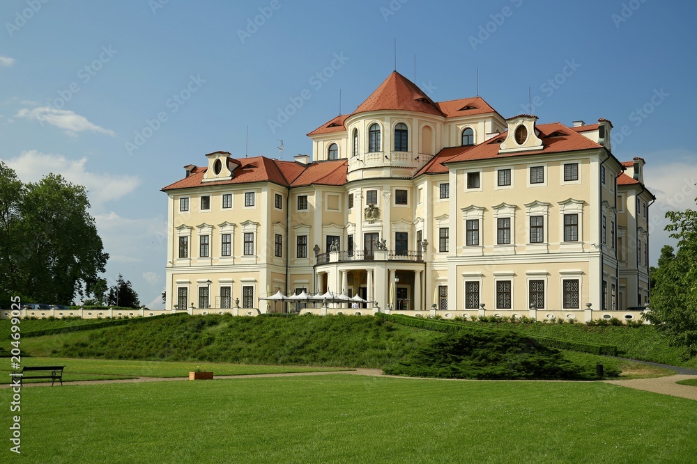 Beautiful castle Liblice close to Melnik, Czech Republic, Europe,  in baroque style with garden, green grass, trees, on a sunny day with blue sky