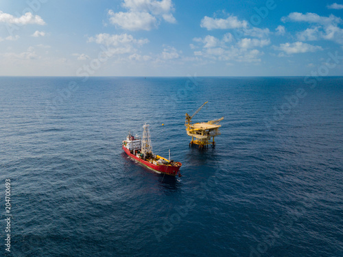 Soil Boring Boat (a geotechnical drilling cum analogue survey vessel) close to a oil platform